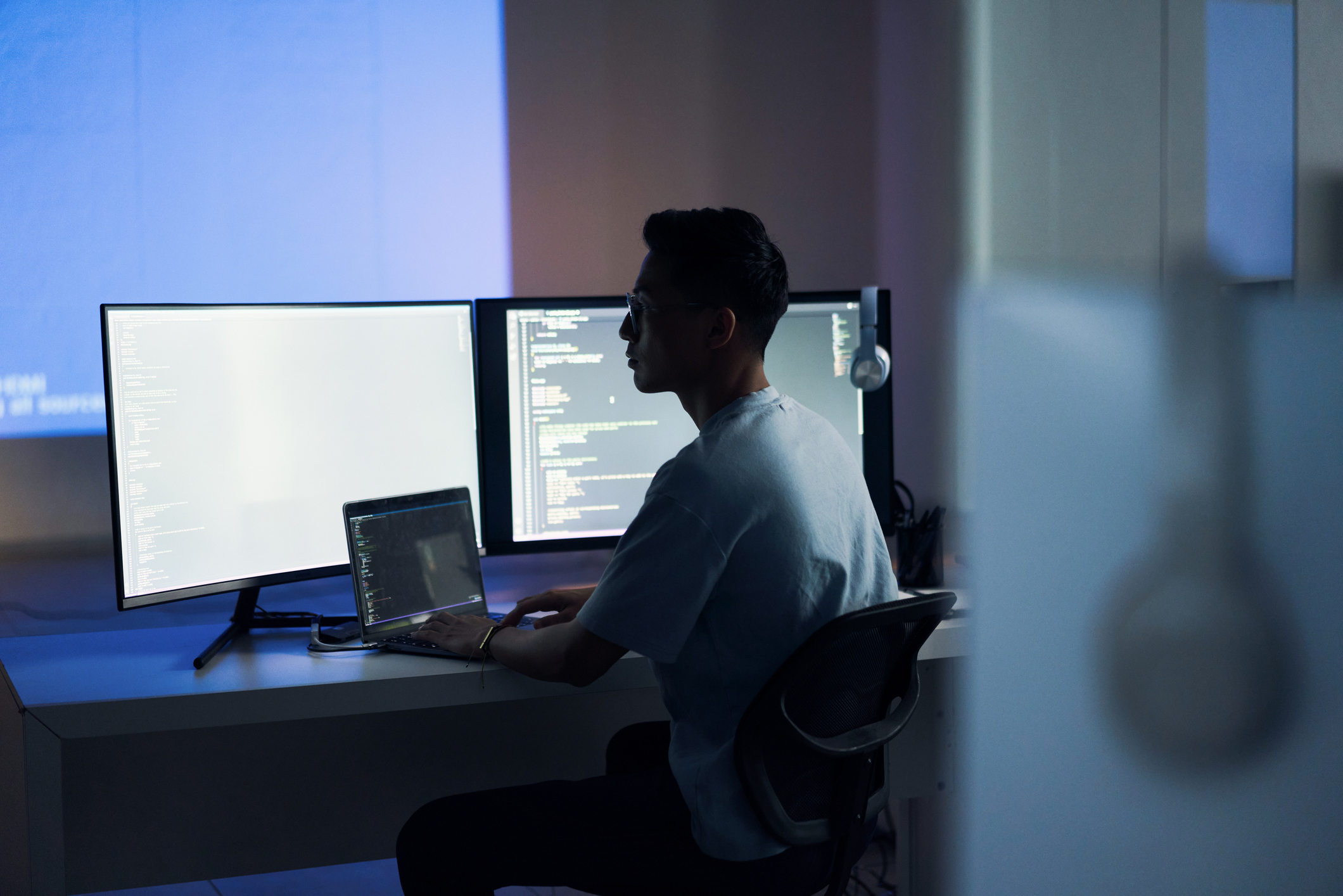 man with a computer for programming a website at night