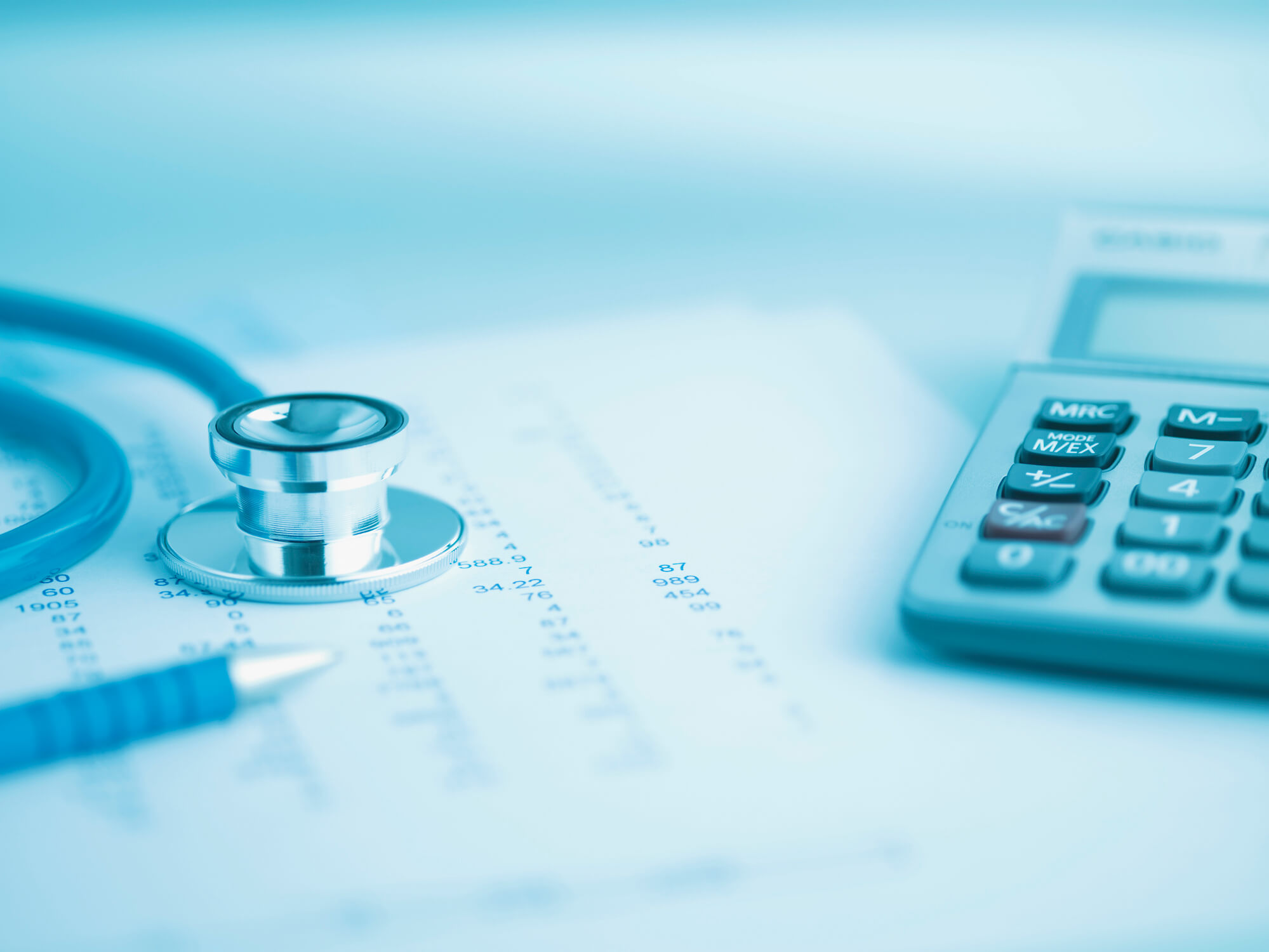 Close up of calculator, data and stethoscope